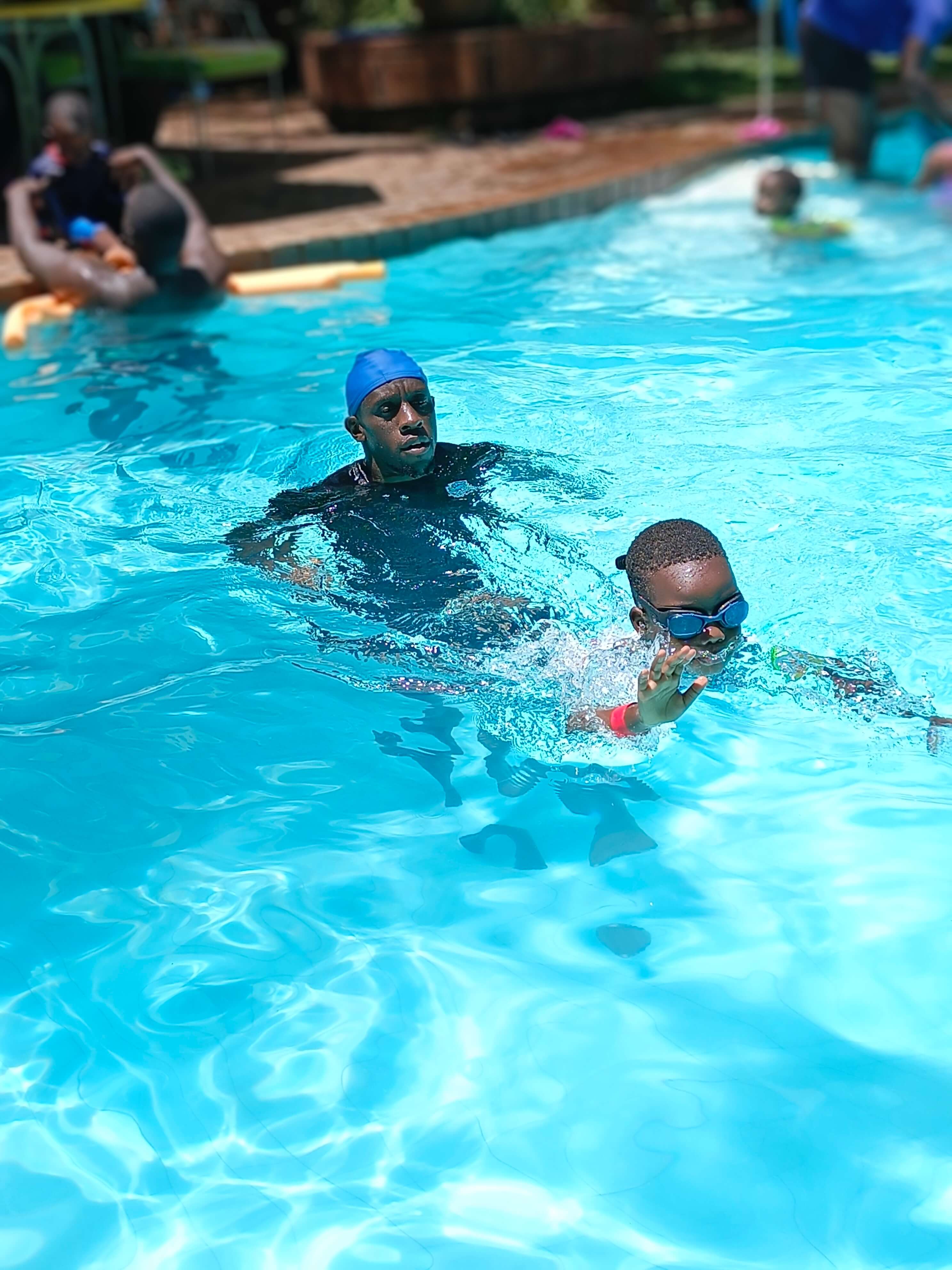 Instructor supporting a child during a calm one-on-one swim lesson